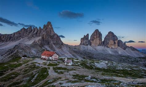 Panoramic View Of Tre Cime And Rifugio Hut Before Sunrise In Summer