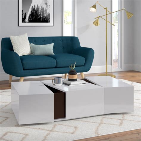 A coffee table is undoubtedly a classic staple that can make or break a room's design, but they aren't just for throwing your feet up anymore. Sleek Modern Coffee Table with Hidden Storage