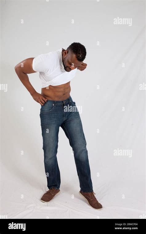 Black Man Pulling Up His Shirt Stock Photo Alamy