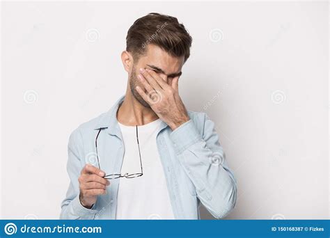 Man Taking Off Glasses Suffers From Dry Eyes Studio Shot Stock Image