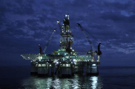 Offshore Oil Rig At Night By Bradford Martin