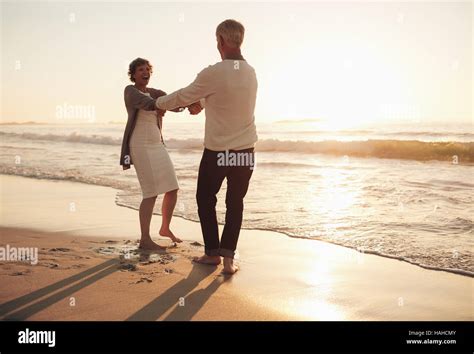 Happy Adult Caucasian Couple Having Fun On The Beach High Resolution