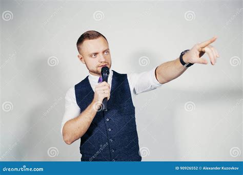 Young Elegant Talking Man Holding Microphone Talking With Pointing