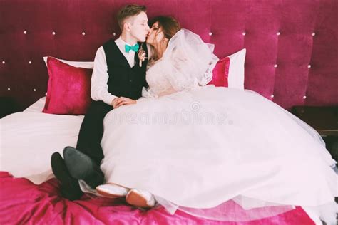 Sensual Bride And Groom Kissing On Crimson Bed Stock Image Image Of
