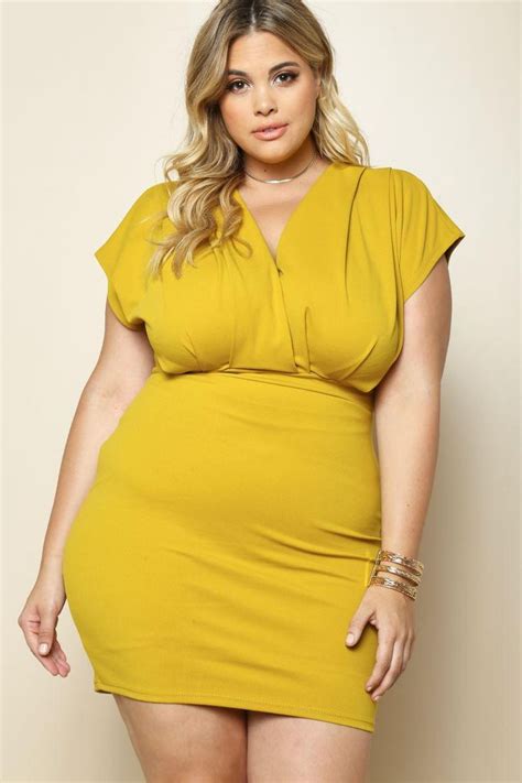 A Contemporary Plus Size Mini Dress Featuring A Surplice Neck Drop