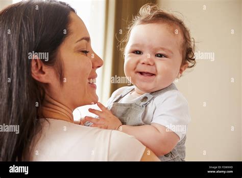 Mother Cuddling Happy Baby Boy At Home Stock Photo Alamy