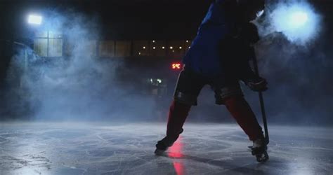 Man Hockey Player With A Puck On The Ice Arena Shows Dribbling Stock