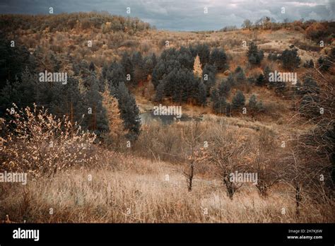 Autumn Hills With Colorful Trees And Lake Under Stormy Sky Stock Photo