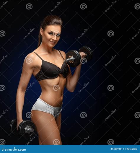 Smiling Athletic Woman Pumping Up Muscles With Dumbbells Stock Image