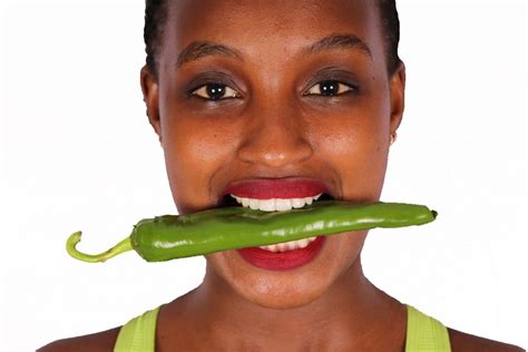 Close Up Woman Biting Green Pepper