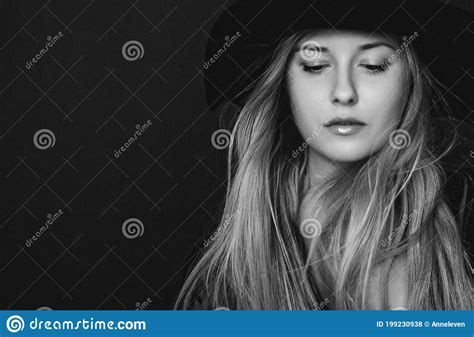 Beautiful Blonde Woman Wearing A Hat Artistic Film Portrait In Black