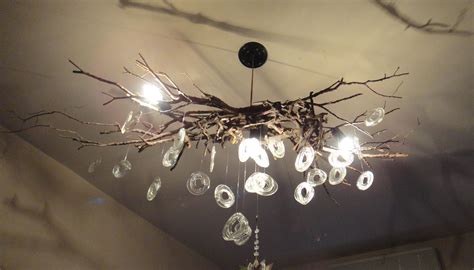 Chandelier Made From Tree Branches And Pieces Of Bottles Melted By