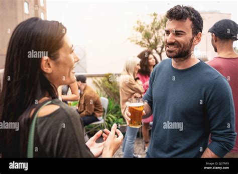 Friends Party On The Rooftop Couple Talking Together Drinking Beers