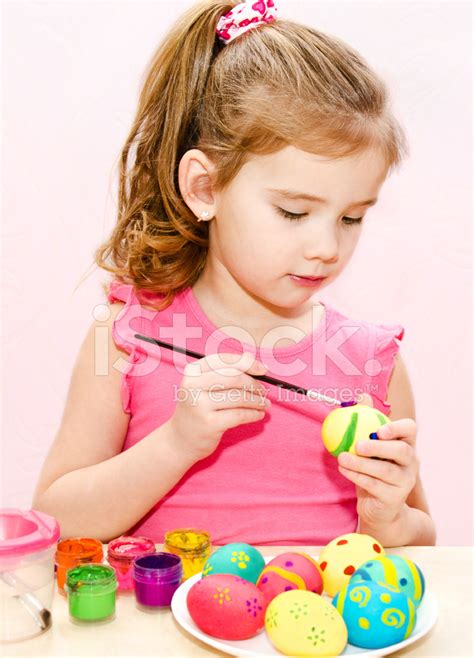 Cute Little Girl Painting Easter Eggs Stock Photos