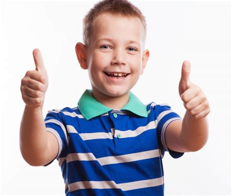 Portrait Of Happy Boy Showing Thumbs Up Gesture Childrens Hearings