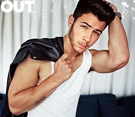 nick jonas flexing his biceps and strutting his stuff for out magazine jonas brothers ♥