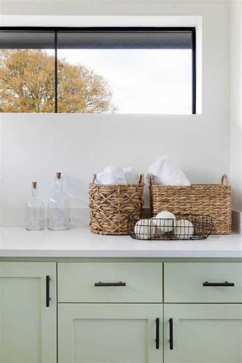In terms of appearance, this is a good thing since kitchens have a wide variety of. Light green laundry room cabinetry + black hardware ...