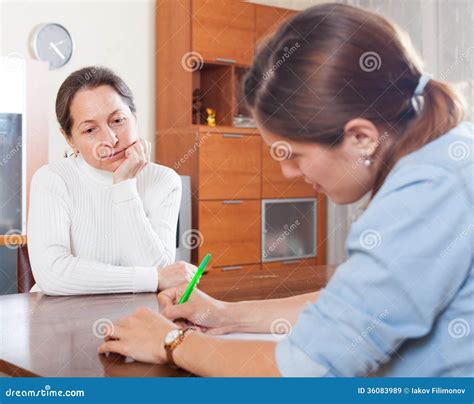Sad Mature Woman Answer Questions Of Outreach Worker Stock Image