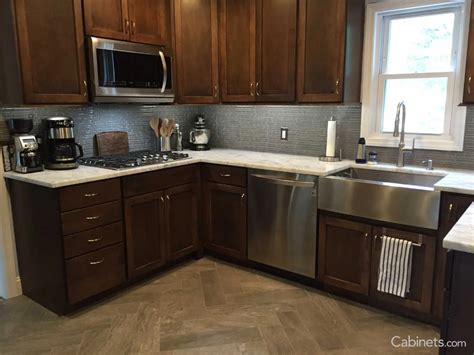 Pecan Stained Kitchen With Stainless Farm Sink And Appliances Cabinets