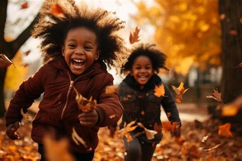 Premium Ai Image Joyful Black Kids Playing In Autumn Leaves On A