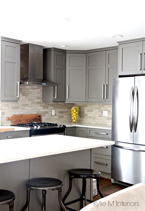 Waterfall white quartz kitchen countertop with dark wooden cabinets. Kitchen painted Benjamin Moore Amherst Gray with white ...