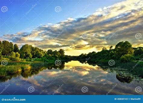 Beautiful Sunset Landscape With Reflection On River Sky And Clouds