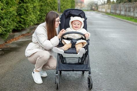 Young Mother Walks With Baby And Carries Him In Beautiful Black