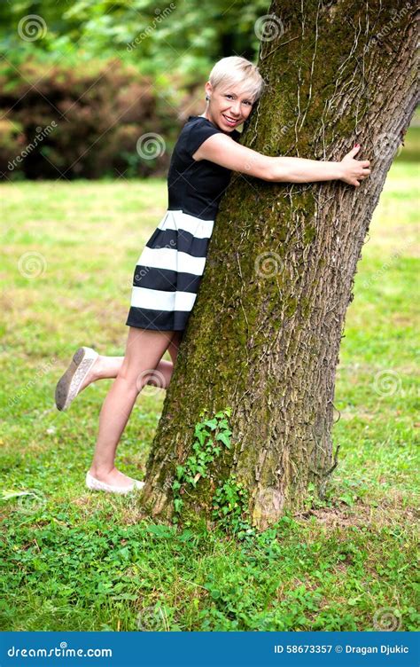 Blonde Girl Hugging The Tree Stock Image Image Of Smiling Shirt 58673357