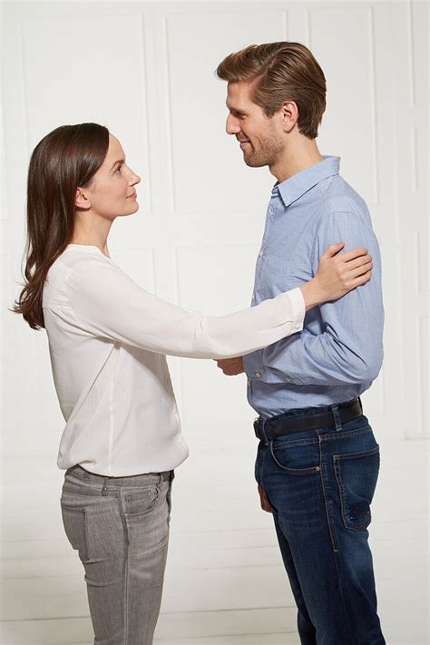 A Woman Touching A Man On The Upper Arm License Image 12499066