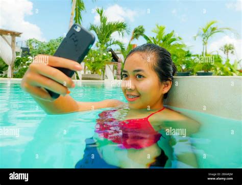 Lifestyle Portrait Of Young Happy And Beautiful Asian Indonesian Teen Girl In Bikini Taking