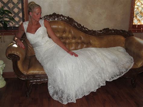 A Woman In A White Dress Sitting On A Couch