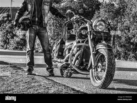 Classic Motorcycle And Biker On The Edge Of The Road Stock Photo Alamy