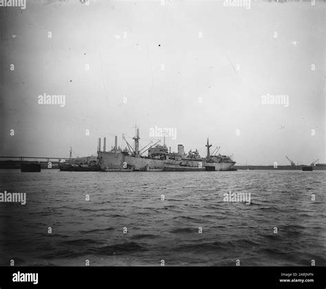 Various Naval Ships Lie Anchored Around A Cargo Ship Annotation On
