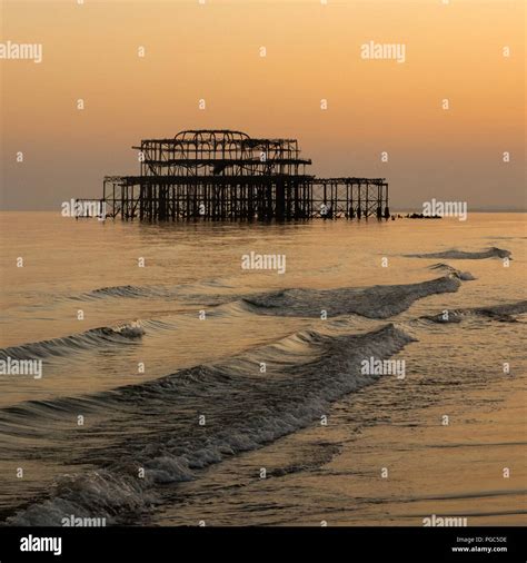 Long Exposure Of Sunset Over Brightons Old West Pier With Waves