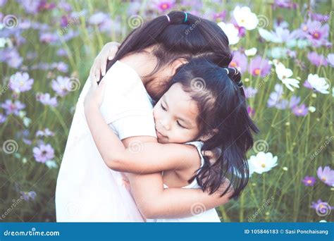 Two Asian Little Girls Hugging Each Other With Love Stock Image Image