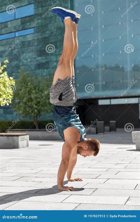 Young Man Exercising And Doing Handstand Outdoors Stock Photo Image