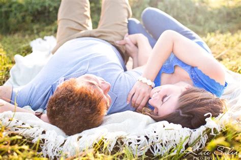 Romantic And Whimsical Engagement Photo Of Couple Laying Down In A Hay