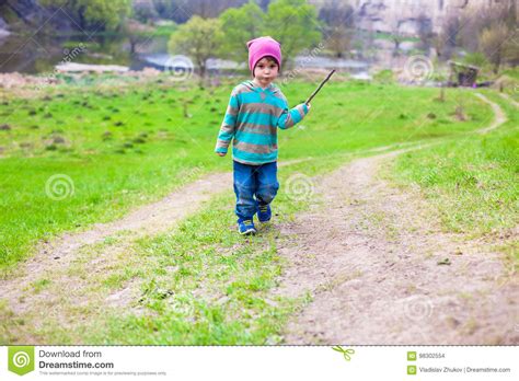 A Boy Walks Through A Meadow Stock Photo Image Of Action Cheerful