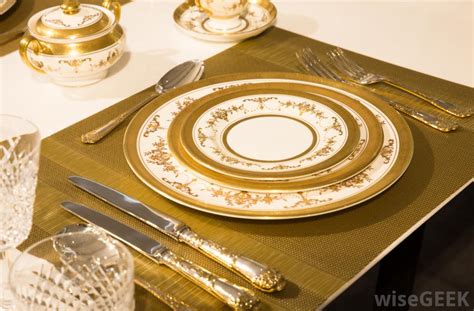 Not only do they anchor the dining table, create ambiance, and are aesthetically pleasing to guests, chargers also protect the table and tablecloth from becoming dirty during service. In a Formal Table Setting, what is a Charger? (with pictures)