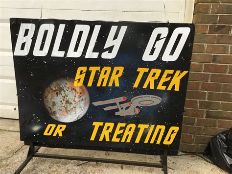 A Star Trek Sign Sitting On The Side Of A Building