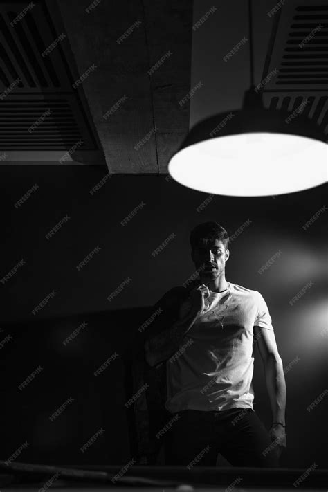 Premium Photo Man Leaning Against Wall Looking Into Light Concept