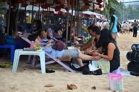 tourists receive a massage on pataya beach from thai women editorial photo image of handsome
