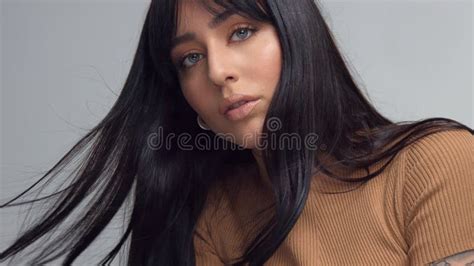 Mixed Race Brunette Woman With Blue Eyes In Studio Stock Photo Image