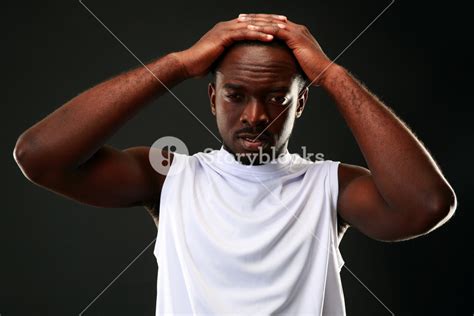 Frustrated African Man Touching His Head Over Black Background Royalty