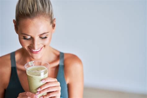 Premium Photo Adult Woman Drinking Healthy Smoothie After Workout