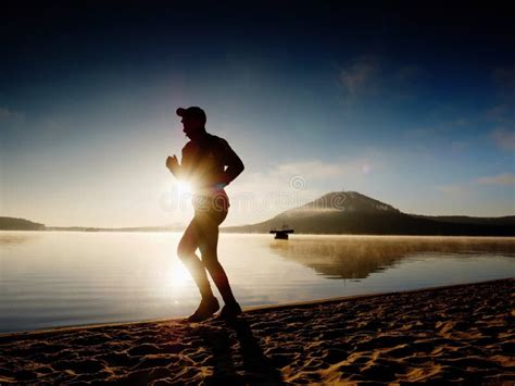 Tall Fit Man Running Along The Sea Shore In Morning Healthy Male