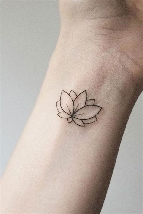 A Small Tattoo On The Wrist Of A Woman With A Lotus Flower In Its Center