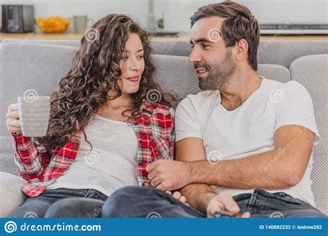 True Love Cheerful Romantic Couple Sitting On The Couch In A Cozy Room