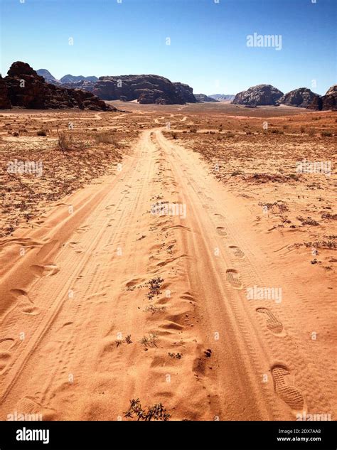 Dirt Road Passing Through A Desert Stock Photo Alamy