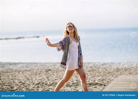 Blonde Girl On The Beach Of The Sandy Beach By The Sea Stock Image